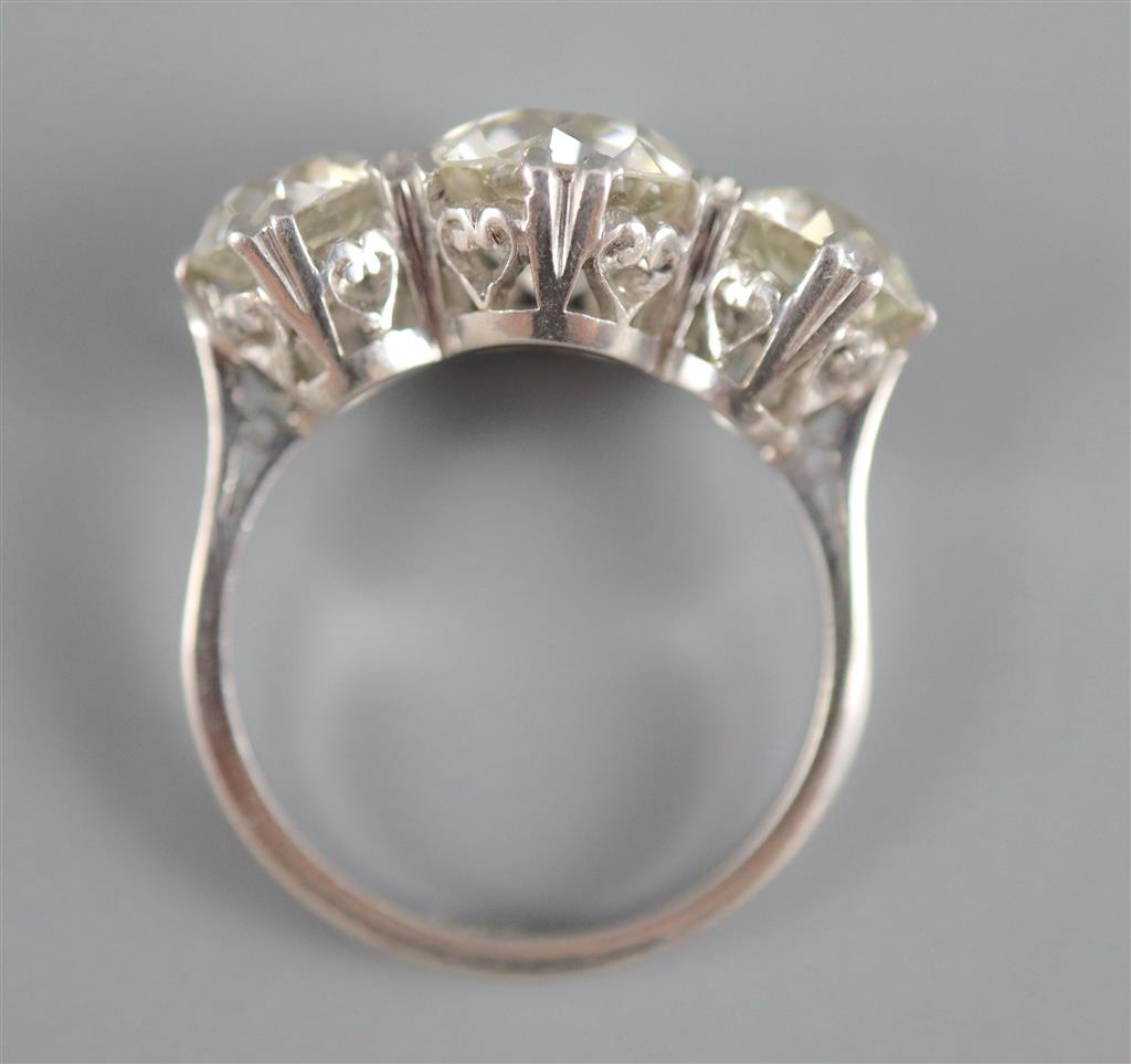 An impressive platinum and three stone diamond ring,